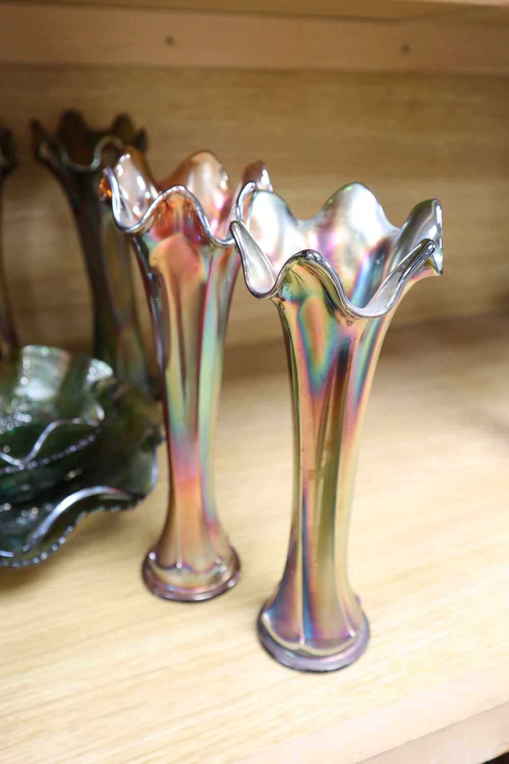 A quantity of mixed green and orange Carnival glass dishes and vases